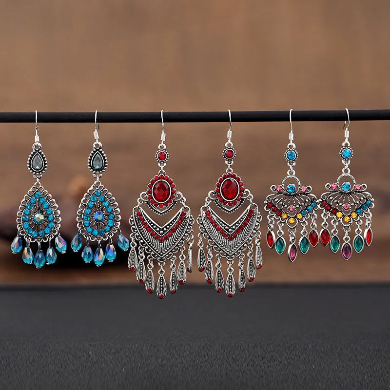 Pair of long purple drop earrings with a cascading fringe design and retro ethnic style.