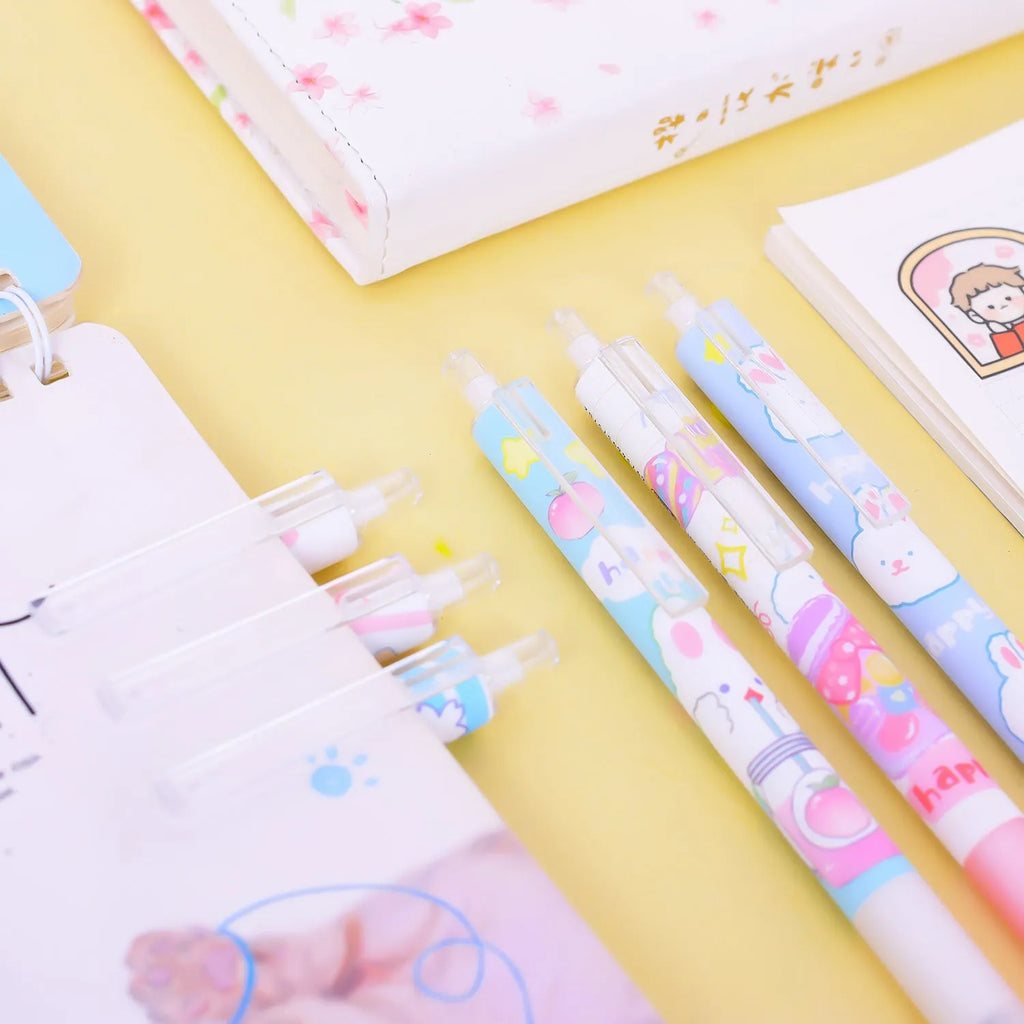 Set of six white plastic pens with black caps and a cartoon bunny character printed on the barrel.