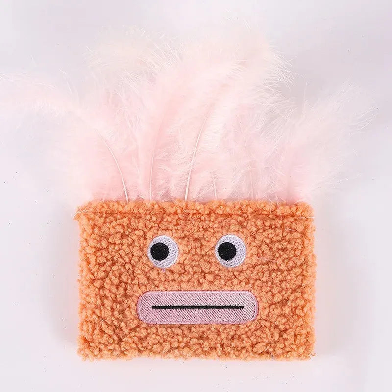 Colourful cat plush toy with a big mouth explosion head shape on a plain background.