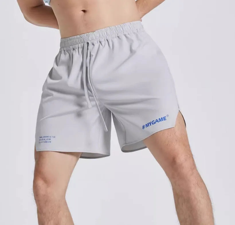Men's training shorts in black, blue, grey, and white colours from a front view.