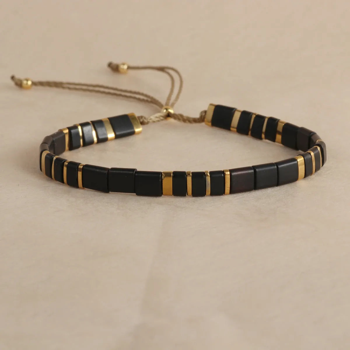 Geometric pull bead bracelet with round glass beads in multiple colour options.