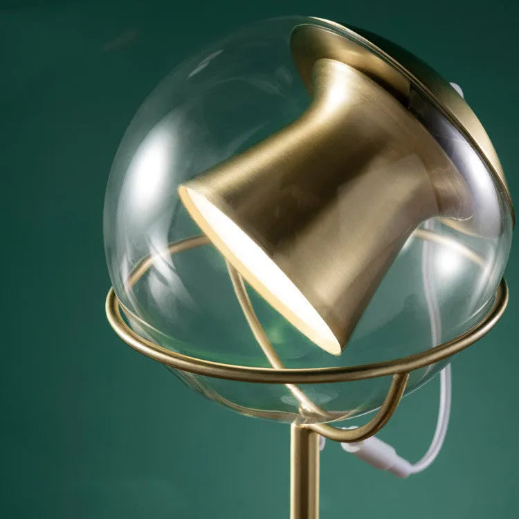 White desk lamp with glass shade and touch-sensitive dimmer switch.