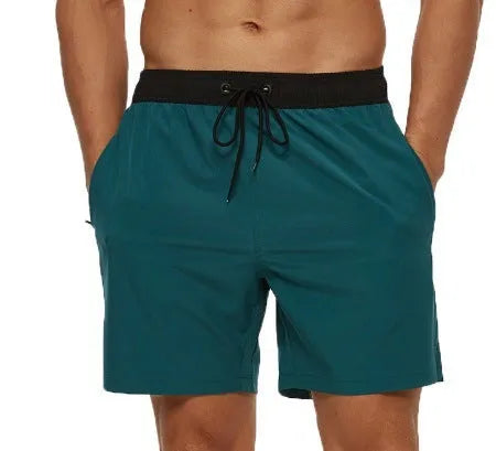 Men's blue fitness shorts with stitching waist detail, drawstring, and multiple pockets for gym workouts