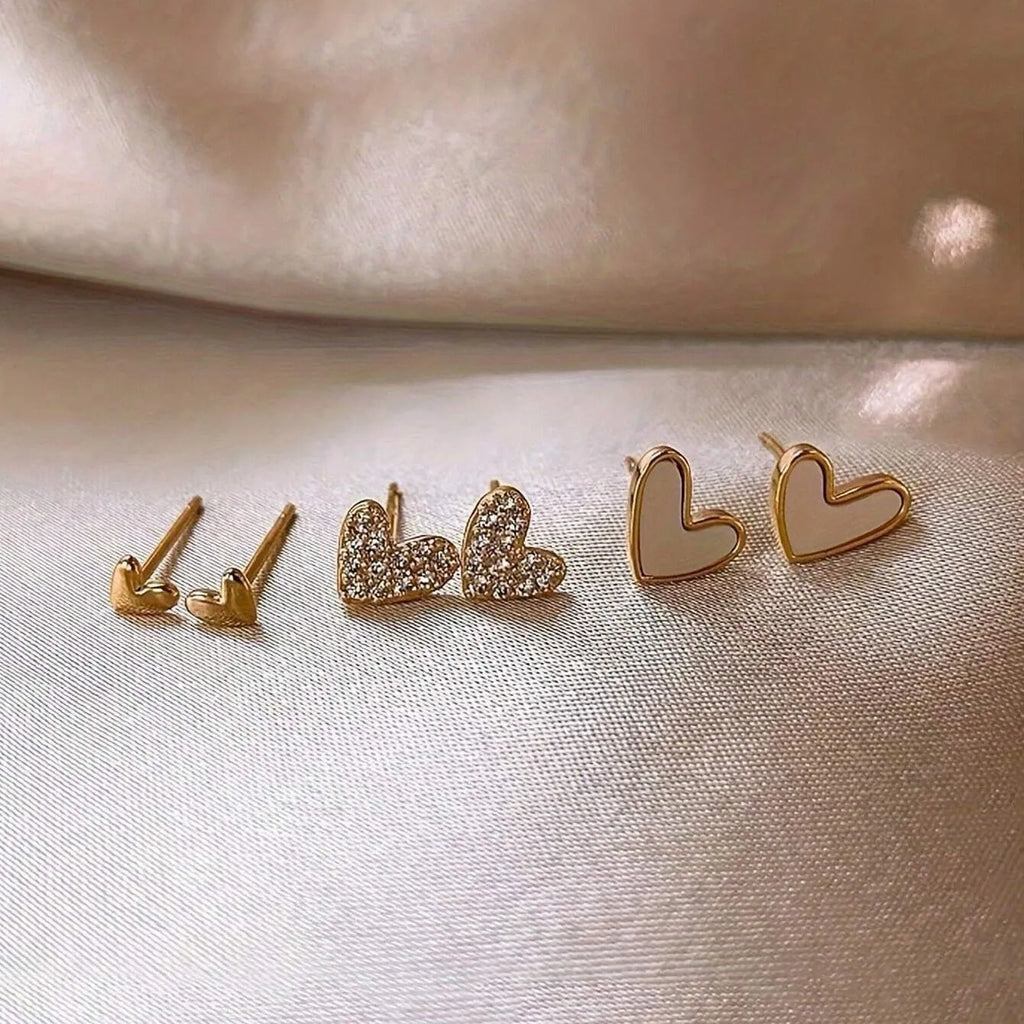 Three pairs of heart shape alloy earrings with electroplated gold, black, pink, and black-white colour options