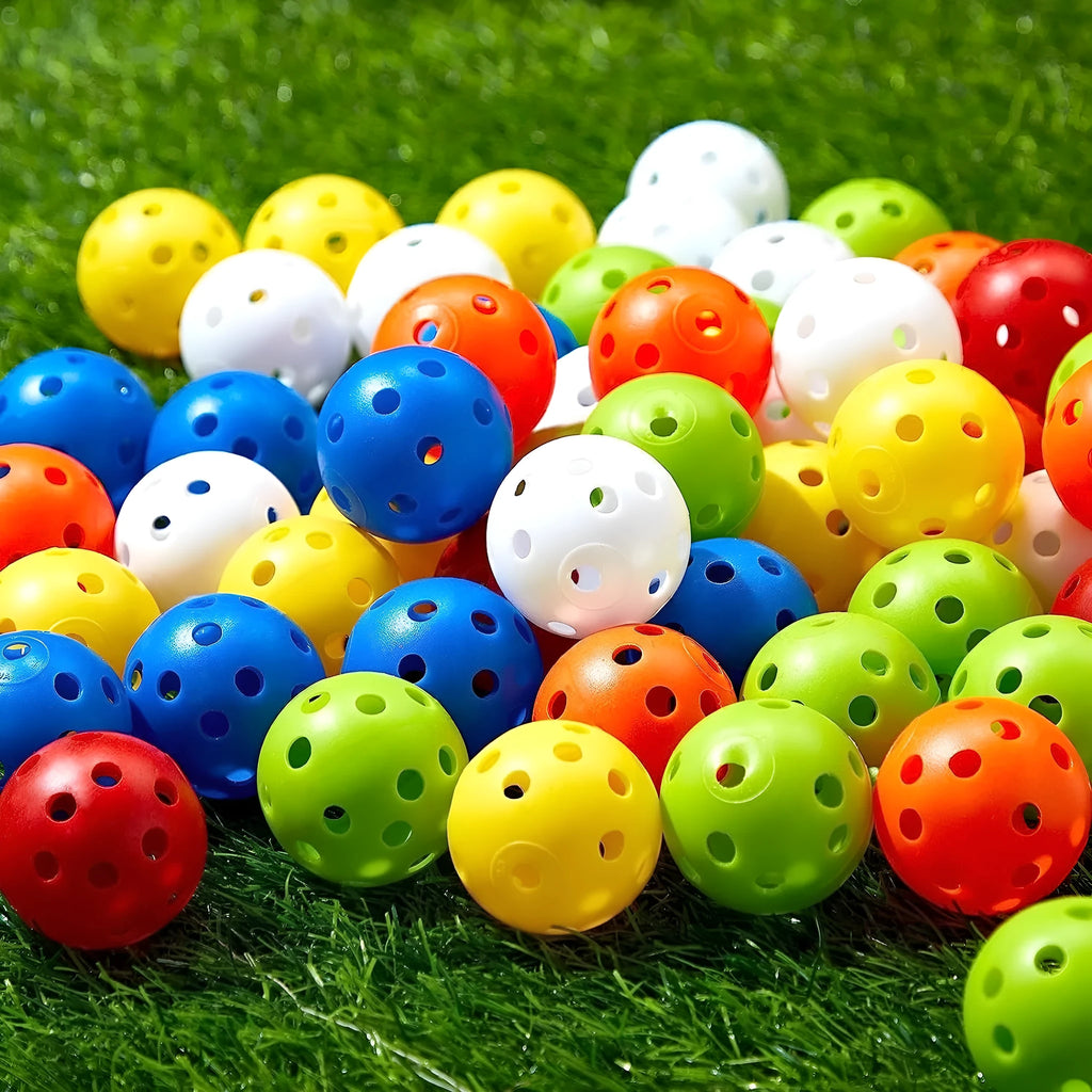 Six multi-colour 42mm golf practice balls in red, orange, blue, green, white, and yellow in a net.