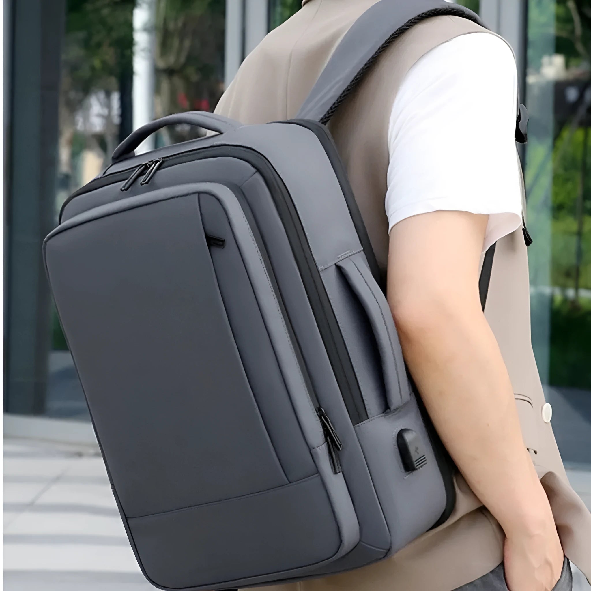 Black business backpack with curved shoulder straps showing waterproof Oxford cloth construction
