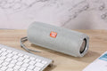 Fabric-covered portable Bluetooth speaker with integrated card holder slot in blue colour