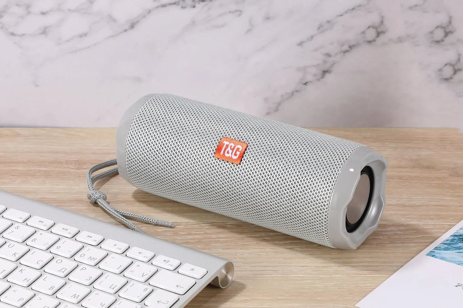 Fabric-covered portable Bluetooth speaker with integrated card holder slot in blue colour