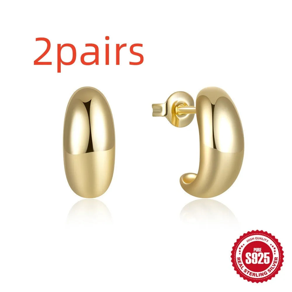 Sterling silver C-shaped stud earrings with electroplated gold finish