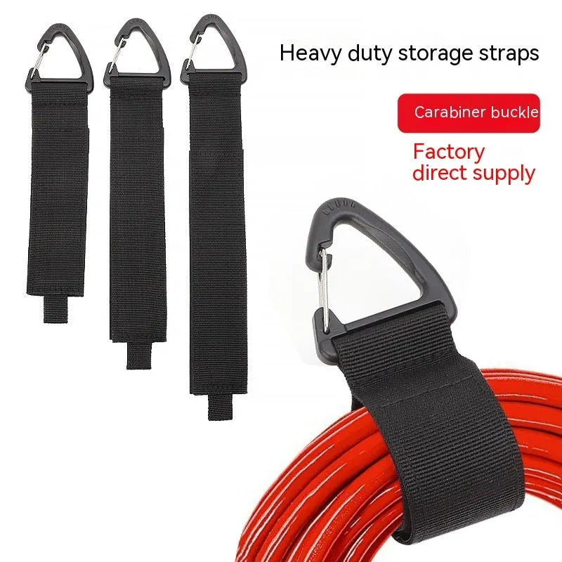 Black heavy-duty adjustable storage strap with metal carabiner clip for garage workshop organisation.