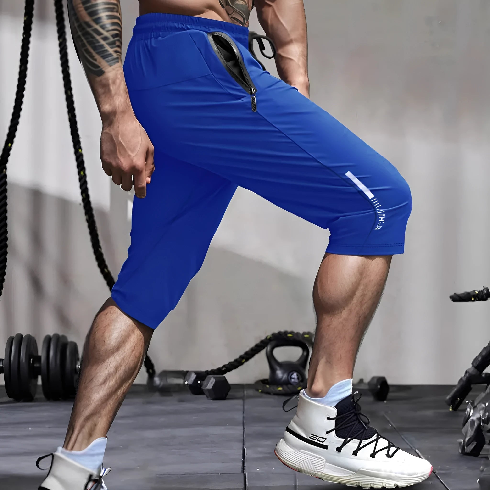 Man wearing black cropped straight-leg sports casual pants made from quick-drying nylon fabric.