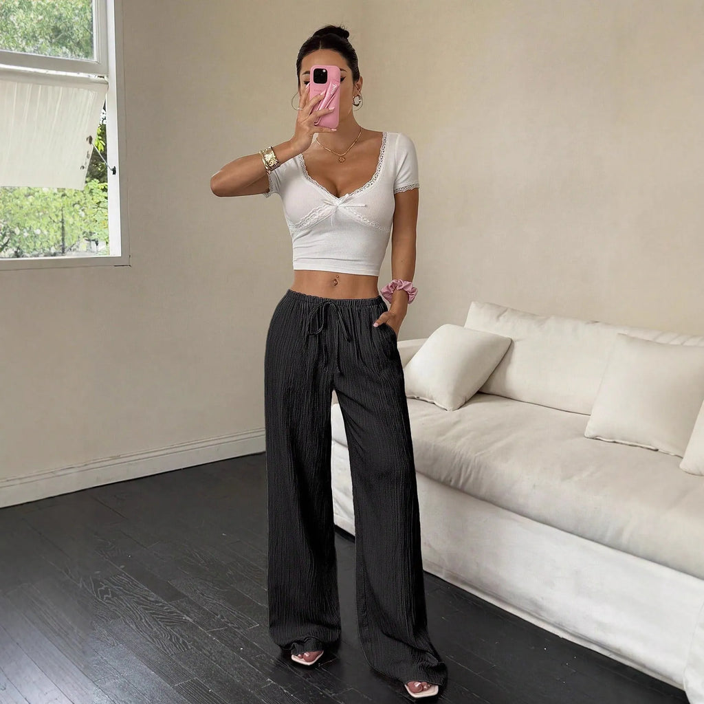 Women's wide-leg trousers with lace-up waist trimming in black and pink polyester fabric