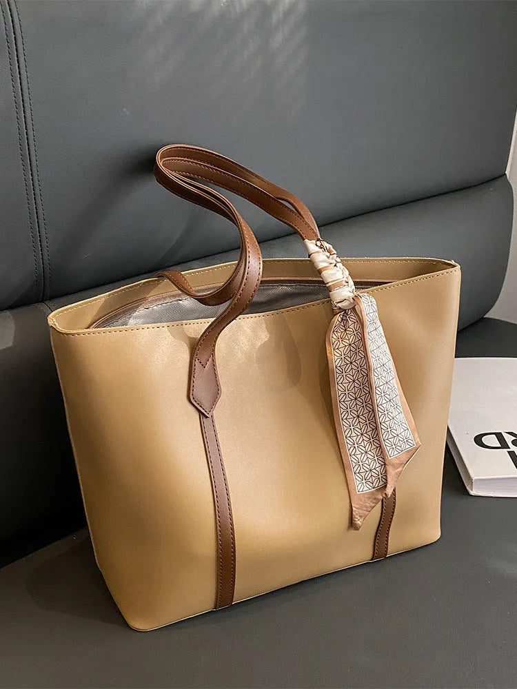 Soft large capacity tote bag with crossbody strap in khaki colour showing outer pocket and sewing line detail