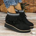 Women's suede ankle boot with wedge heel, side zipper, and tassel detail in dark brown.