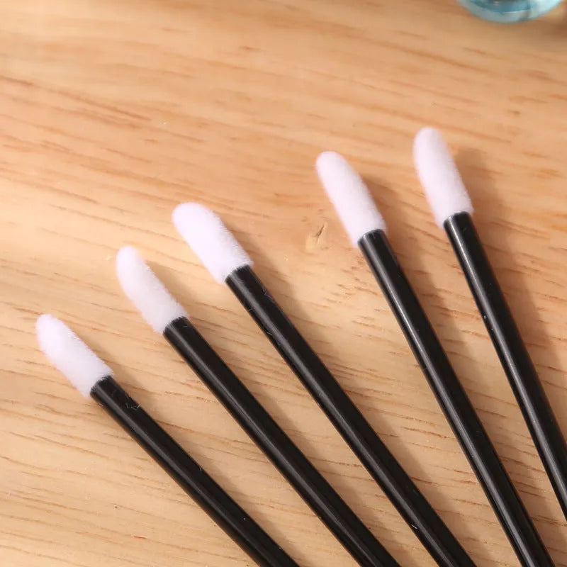 Disposable lip brushes with flocked heads and black handles in various colours