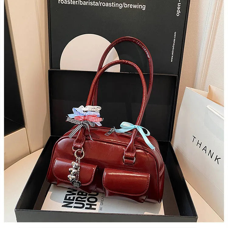 Retro pillow-shaped leather women's handbag with one shoulder underarm design in black with ribbon pendant