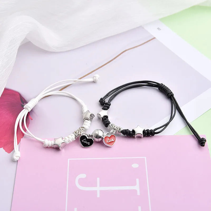 Alloy couple bracelets with magnet closure showing various design options including crown, clover, and text patterns