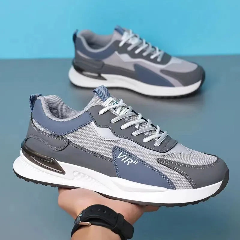 Men's colour block mesh running sneakers in black, grey, and white on a plain background.