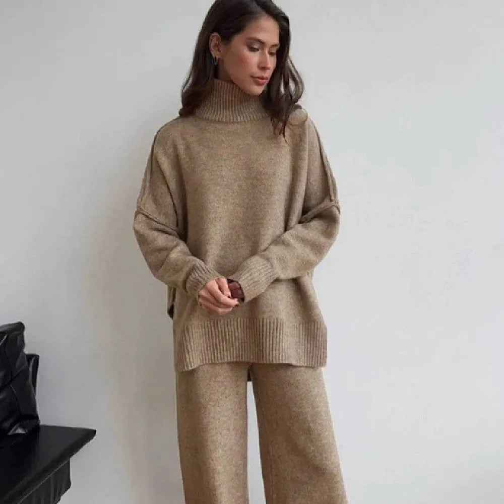 Women's dark grey side-slit sweater and trousers suit set on a hanger