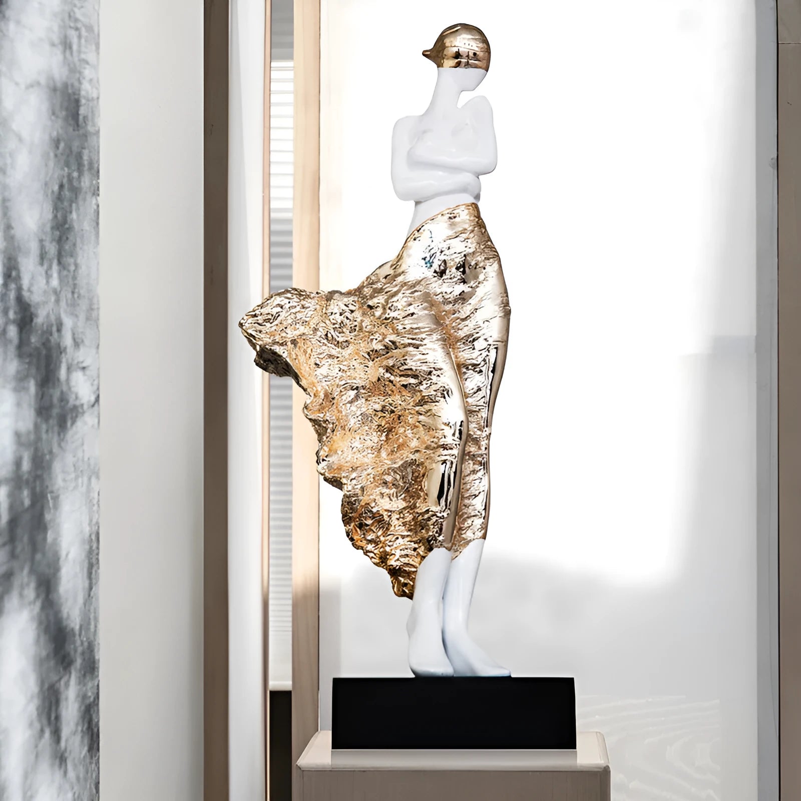 Tall gold resin character sculpture ornament with modern minimalist design on wooden surface