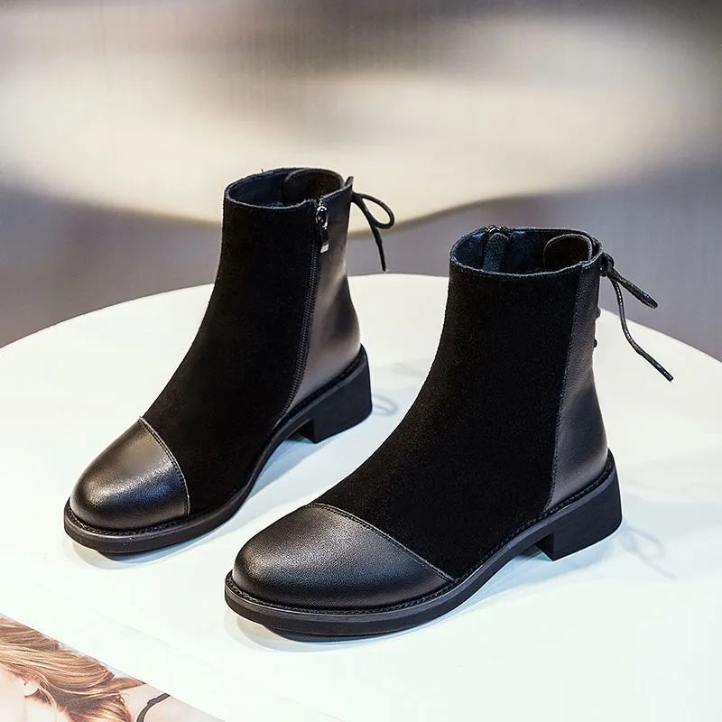 Women's black knee-high Martin boots with side zip closure and bow detailing