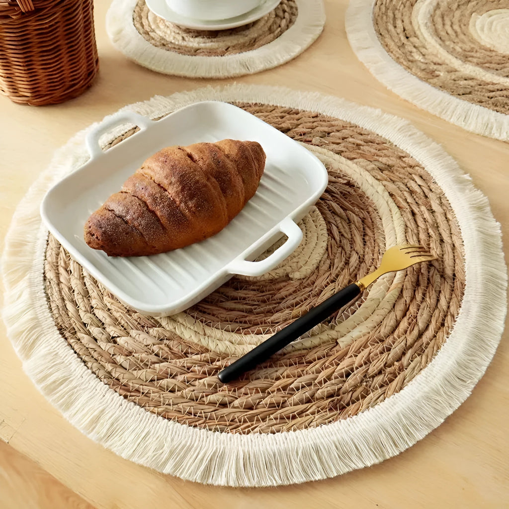 Round papyrus straw placemat with decorative tassels in modern solid colour design
