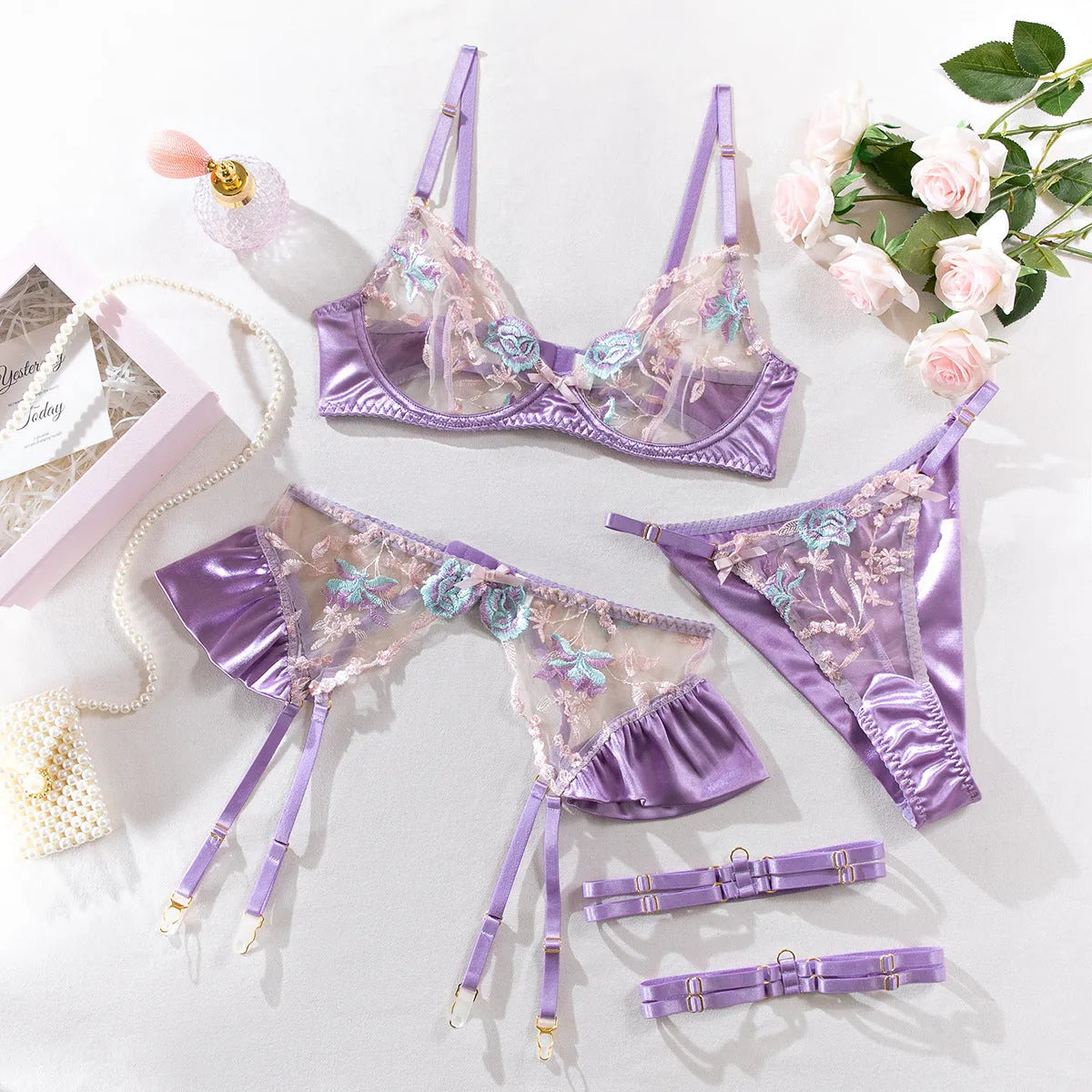 Light purple satin lingerie four-piece set with embroidery details on mercedized fabric