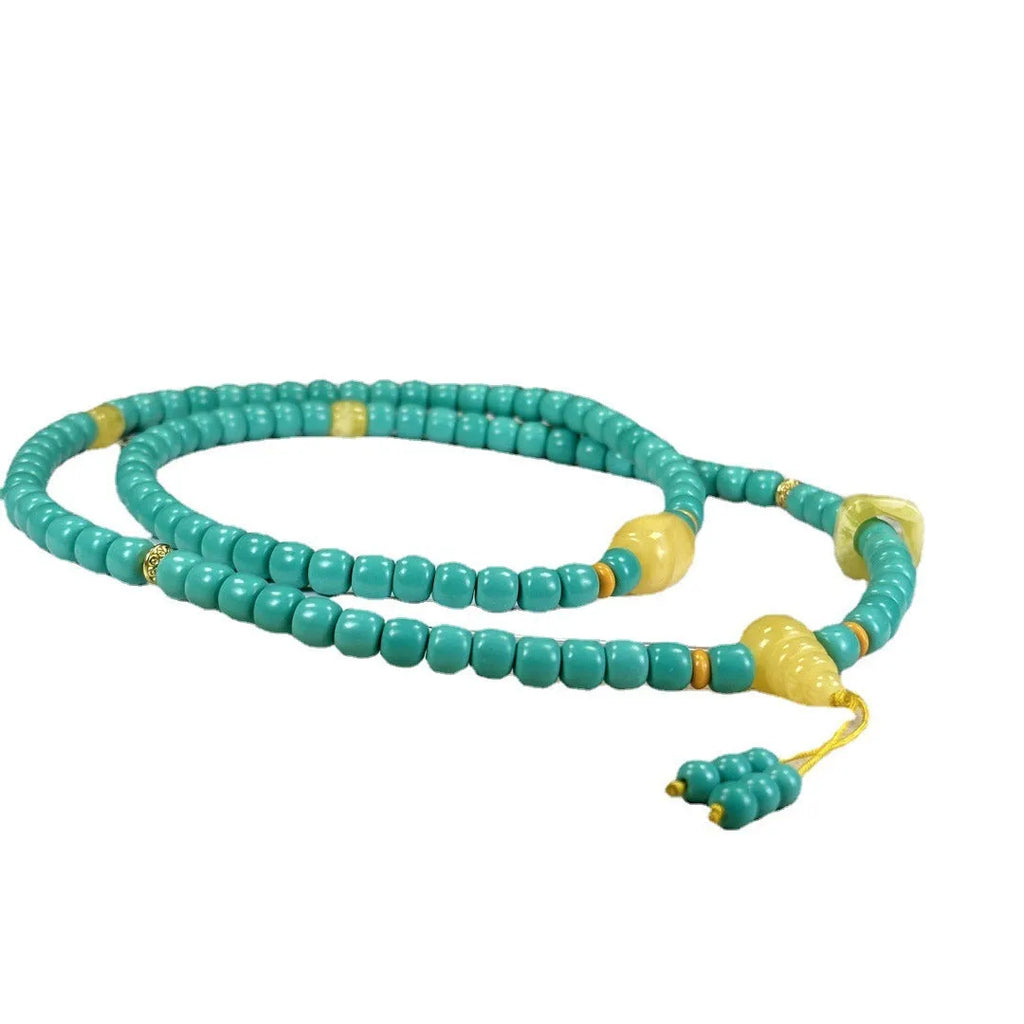 Turquoise stone pendant with hand-woven mesh flower design on a ball bead necklace chain.