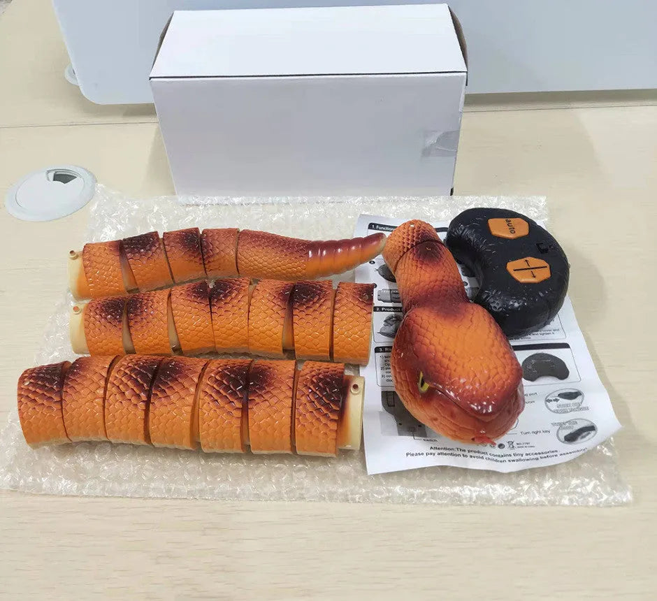 Automatic electronic snake cat toy with segmented plastic body on a floor.