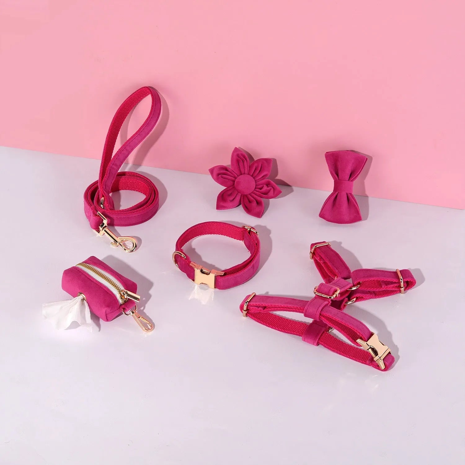 Red velvet dog collar and leash set with chest strap, bow tie, and decorative flower accessories.