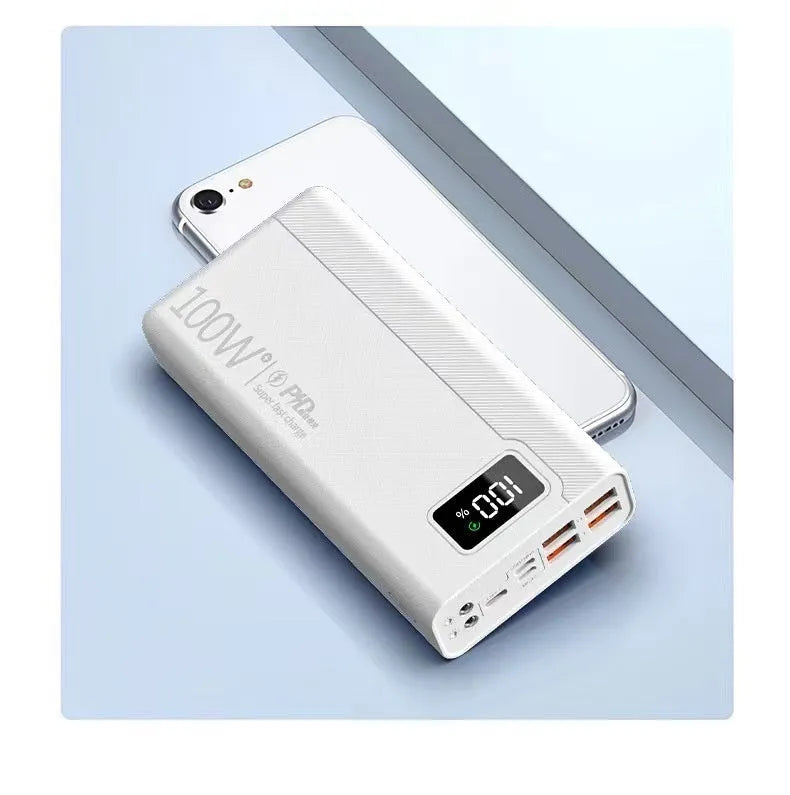 Large capacity black and white plastic power bank showing size relative to a smartphone.