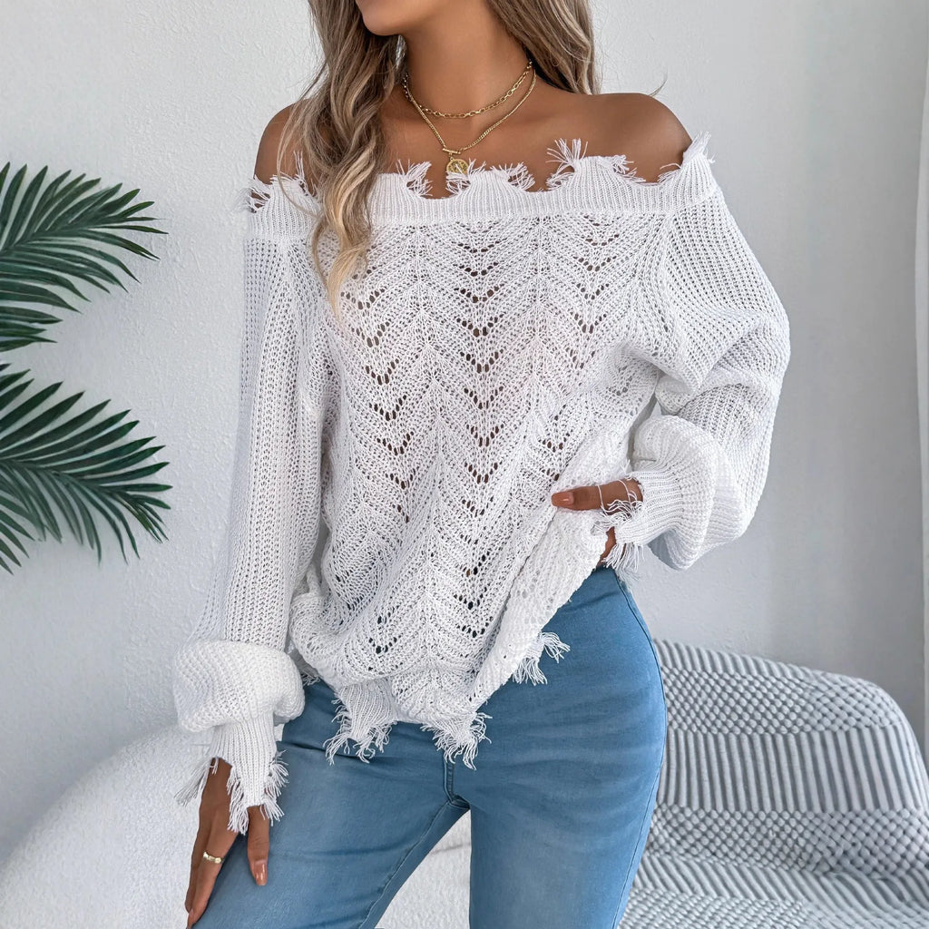 White women's hollow-out knit pullover sweater with long sleeves and an off-the-shoulder neckline.
