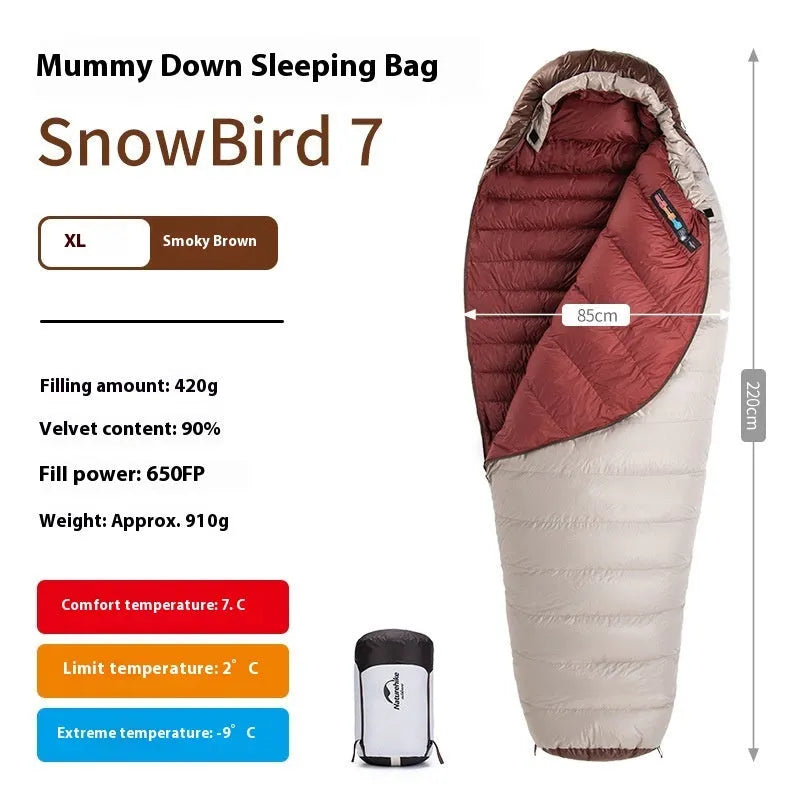 Adult mummy-style sleeping bag with goose down insulation shown with its storage bag.