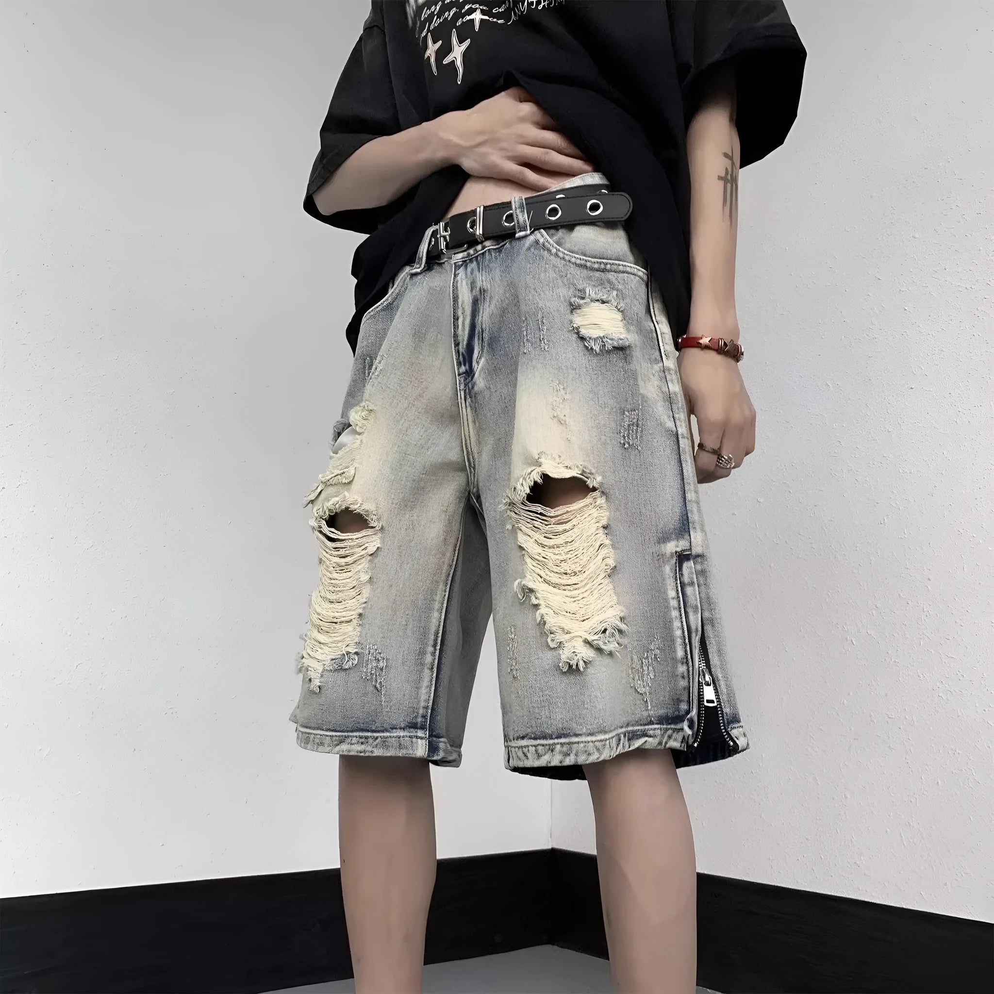 Blue distressed denim shorts with wide-leg loose fit and retro tattered styling on hanger