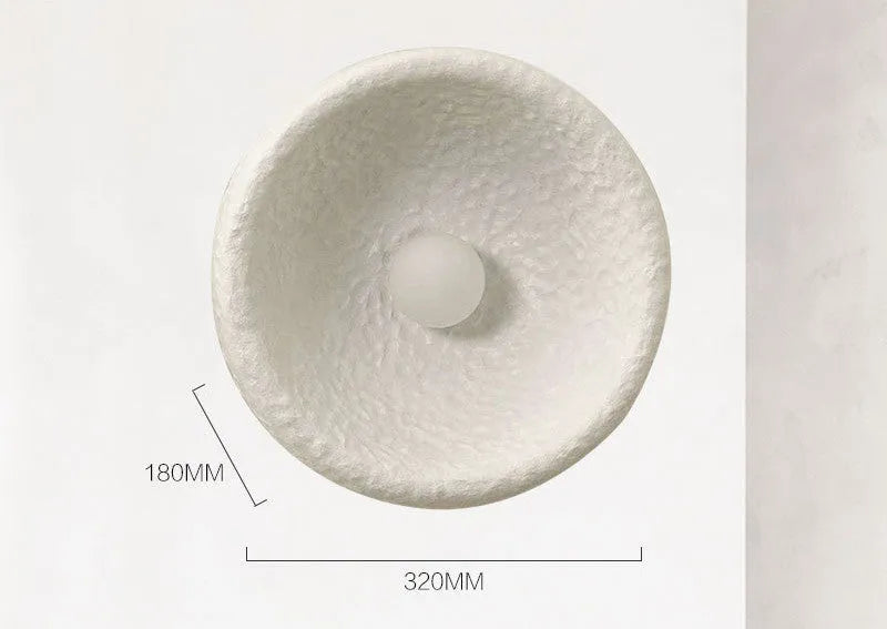 Japanese-style wall lamp with resin shade in three diameter sizes on white wall