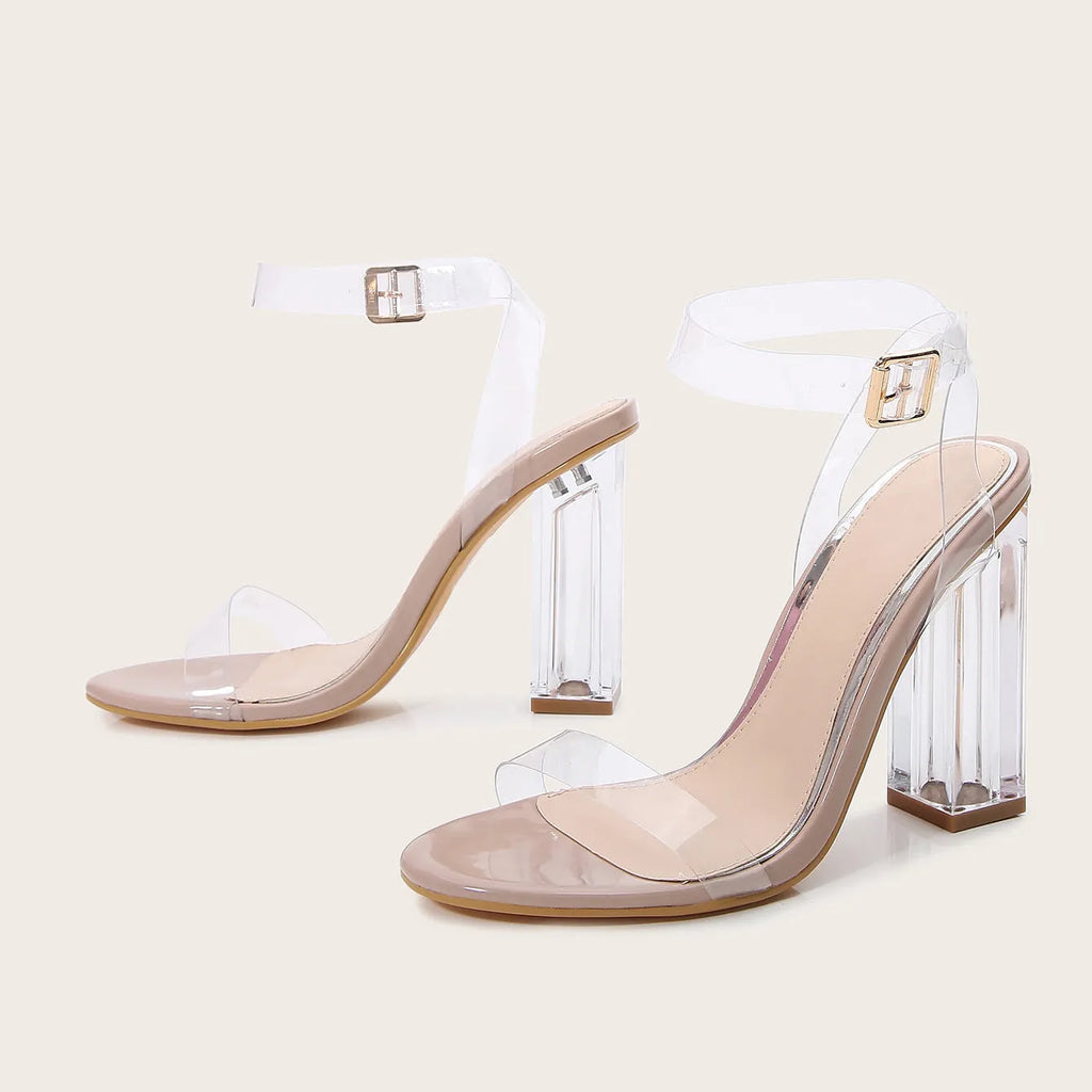 Apricot coloured women's high heel sandals with a clear glass heel and a buckle strap across the foot.