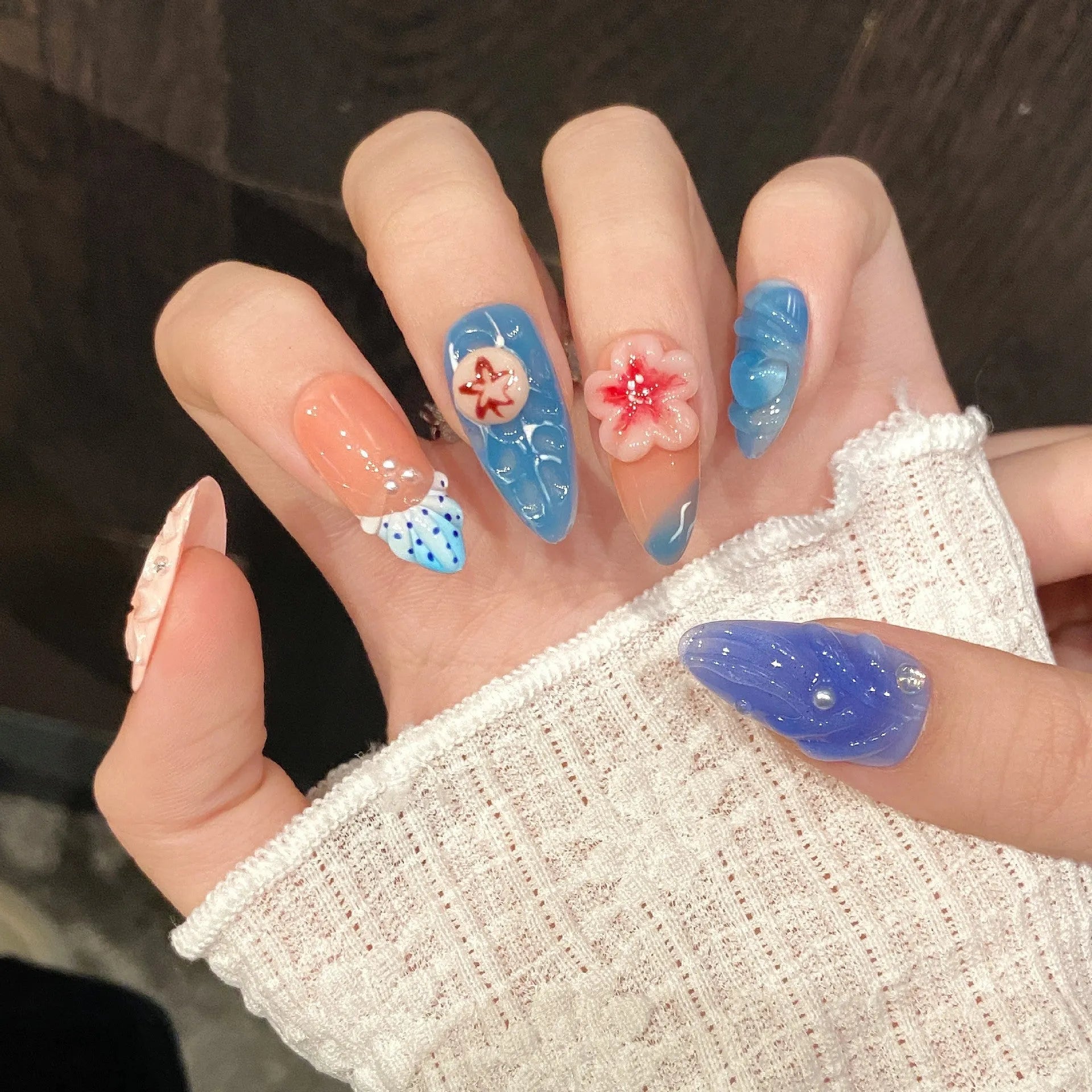 Three-dimensional carved jellyfish design on plastic marine-style wearable armour in almond nail colour.