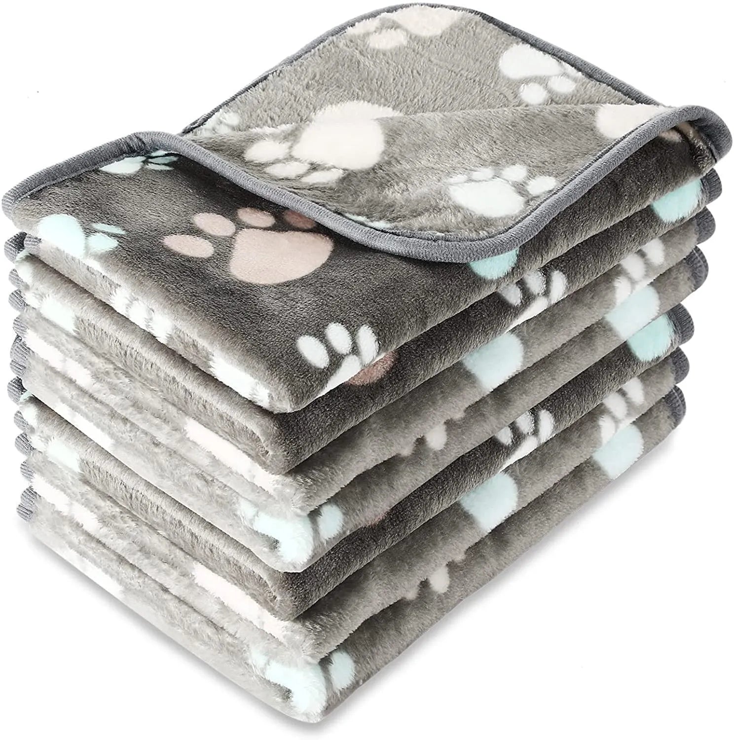 Coral fleece pet blanket with dog's paw print pattern in beige, shown in a large size on a dog bed.
