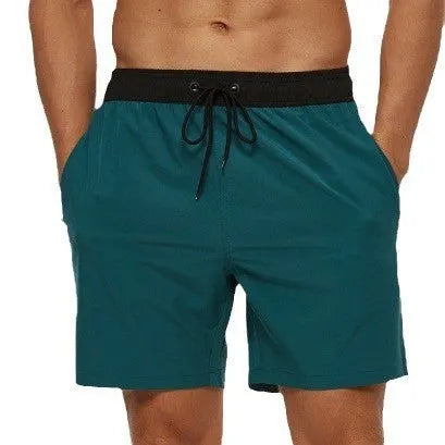 Men's blue fitness shorts with stitching waist detail, drawstring, and multiple pockets for gym workouts