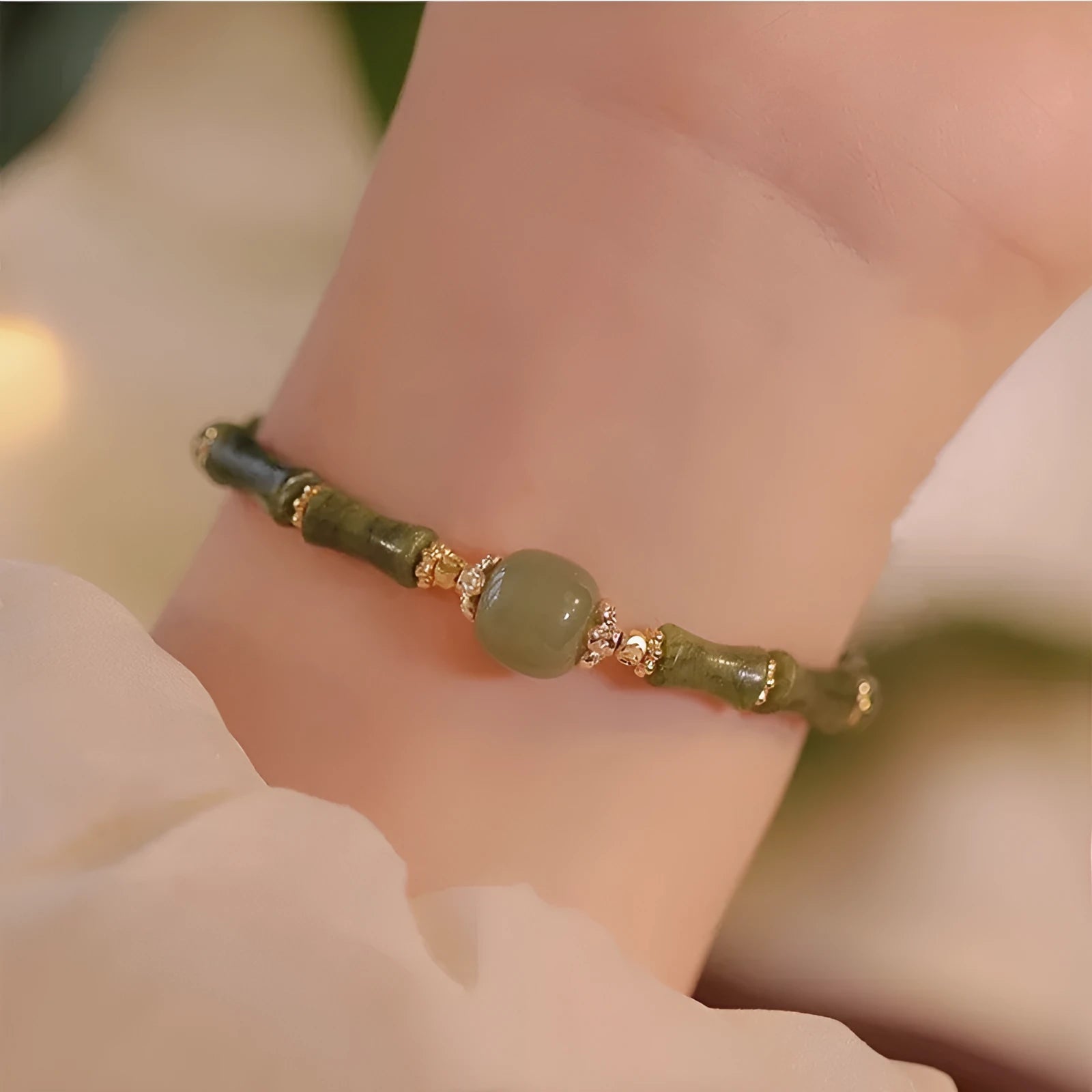 A geometric beaded bracelet made from dark green Hetian jade for women, showing a simple round style.