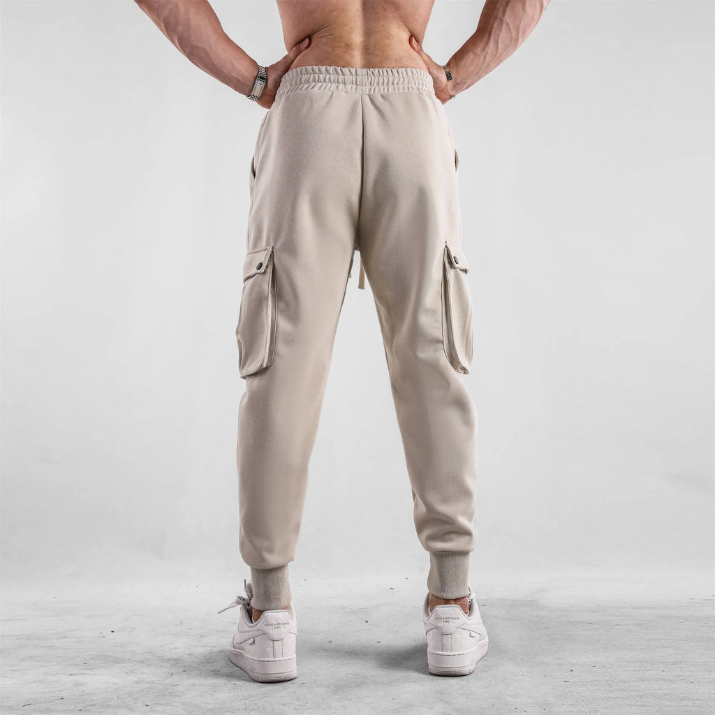 Men's loose light gray cotton trousers with ankle-tied cuffs and multiple pockets