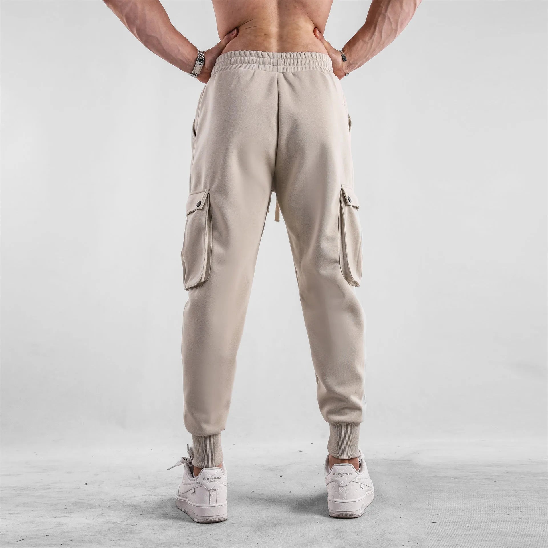 Men's loose light gray cotton trousers with ankle-tied cuffs and multiple pockets