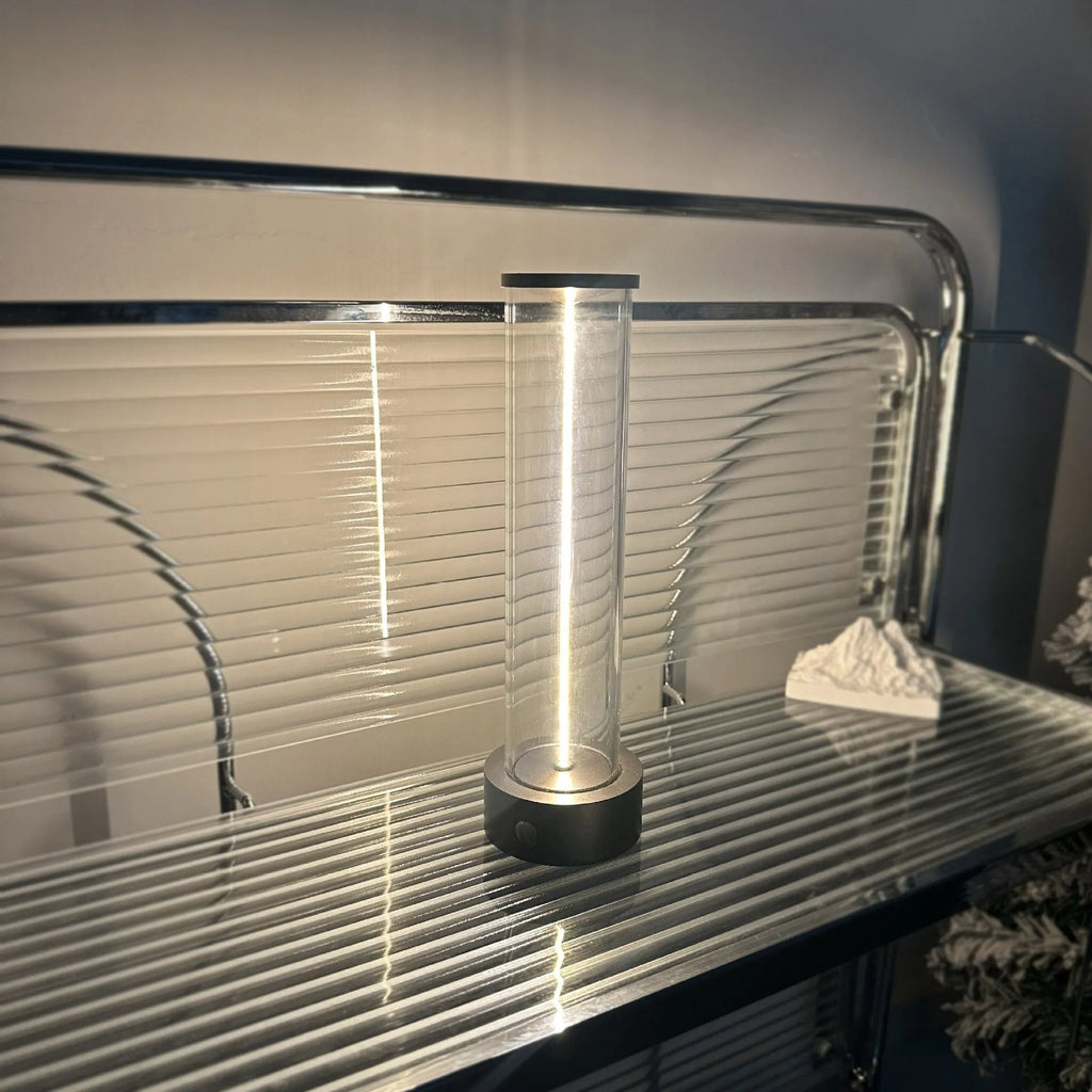 Modern glass and metal LED line light strip with magnetic back for USB-charged night lighting