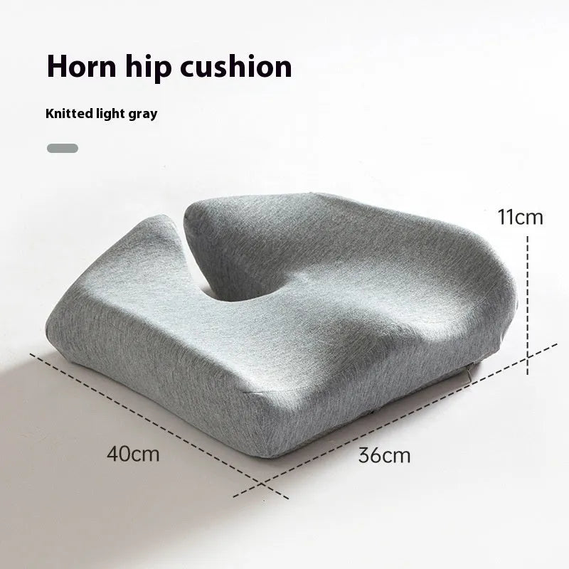 A solid grey memory foam office chair cushion for lumbar support.