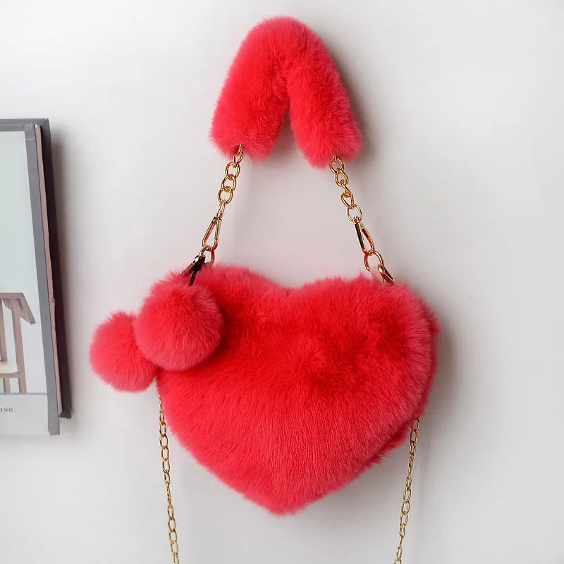 A soft plush heart-shaped women's handbag with a zipper and a detachable shoulder strap in a choice of 14 colours.