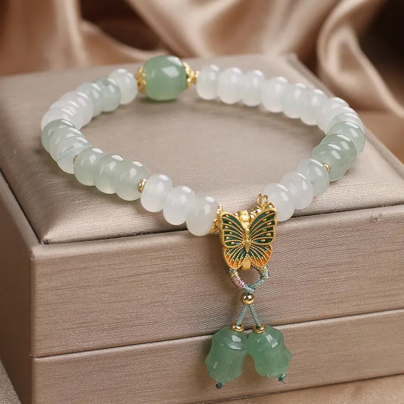 Green crystal abacus bead bracelet with retro butterfly tassel and pearl accents on a 17cm chain.