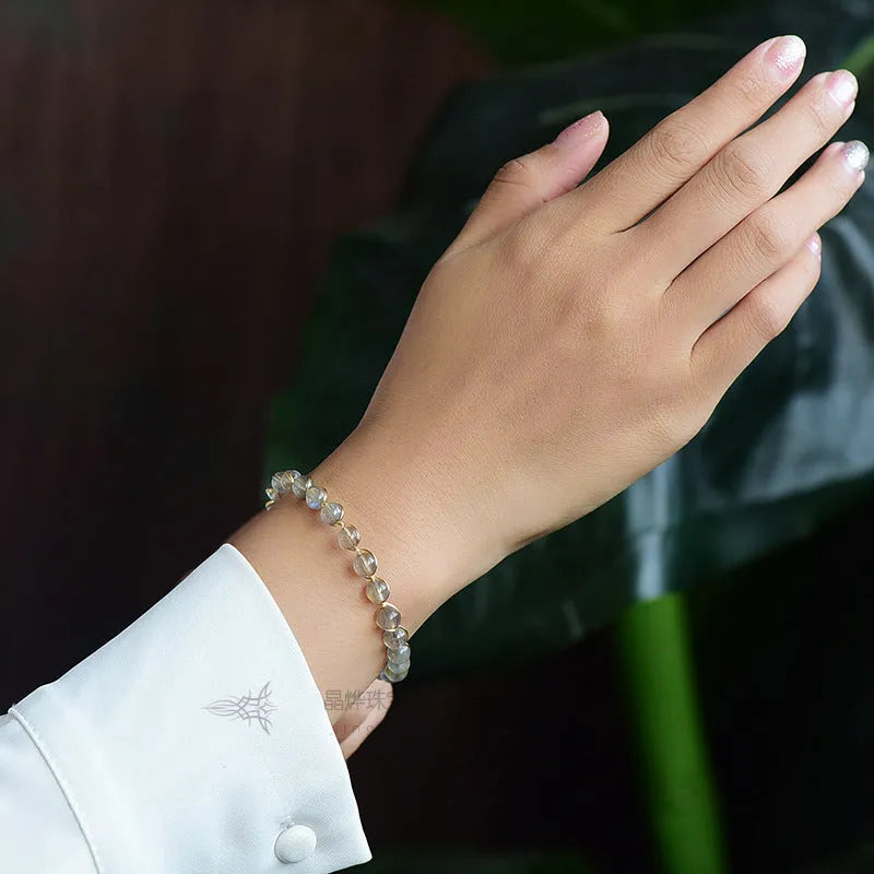 Women's blue moonstone bracelet with 6mm crystals in 14K gilded setting featuring starry sky design