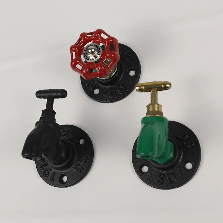 A polished metal wall hook in a water pipe design, shown in black, green, and red colour options.