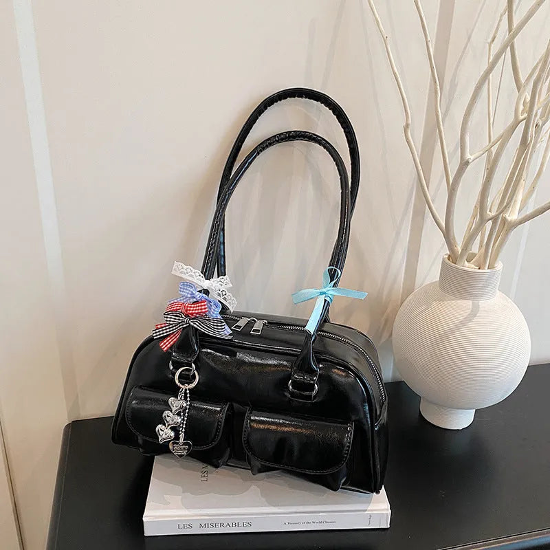 Retro pillow-shaped leather women's handbag with one shoulder underarm design in black with ribbon pendant