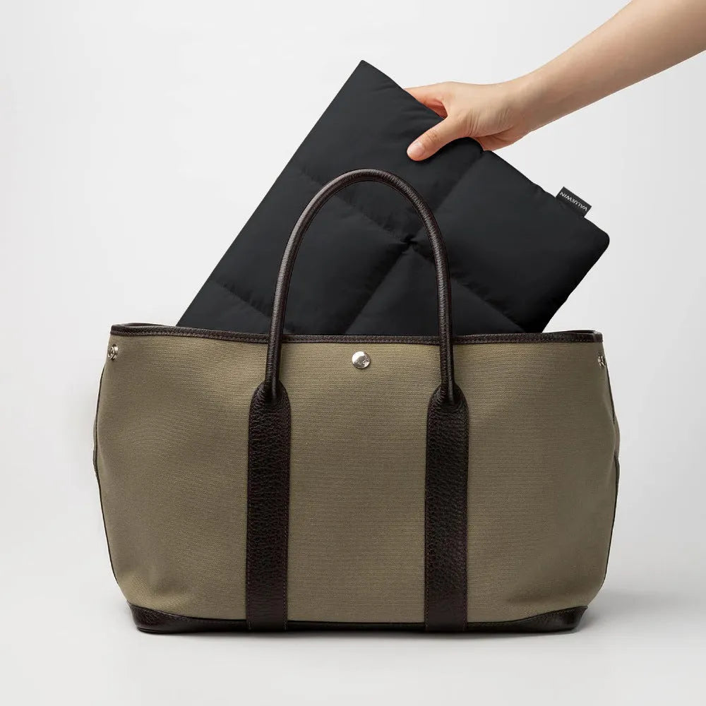Soft black polyester laptop sleeve for a 15.6-inch device with sewing thread detail.
